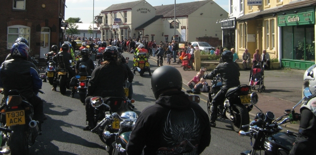 bikes and riders in the street between the crowds